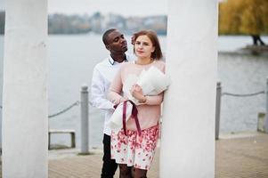 Happy multiethnic couple in love story. Relationships of african man and white european woman. photo