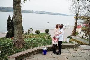 Happy multiethnic couple in love story. Relationships of african man and white european woman. photo