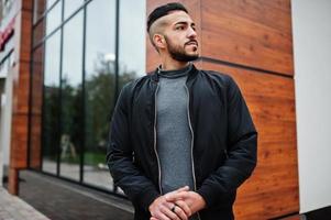 Portrait of stylish arab beard man wear grey turtleneck and black jaket. Arabian model guy. photo