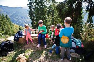 Family with four kids resting in mountains. Travel and hiking with childrens. photo