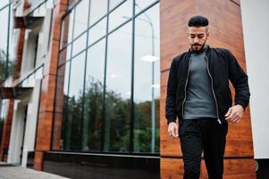 Portrait of stylish arab beard man wear grey turtleneck and black jaket. Arabian model guy. photo