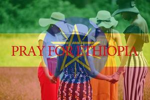 Pray for Ethiopia. Group of four african women holding hands and praying. Concept of crisis in Africa country. photo