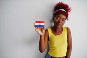 African american woman with afro hair, wear yellow singlet and eyeglasses, hold Paraguay flag isolated on white background. photo