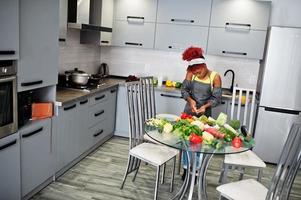 African american woman filming her blog broadcast about healthy food at home kitchen. photo