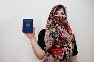 Young arabian muslim woman in hijab clothes hold Lao People's Democratic Republic passport on white wall background, studio portrait. photo