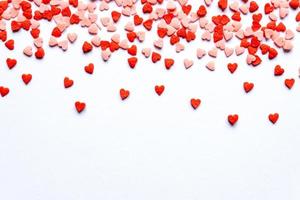 sprinkles background, sugar sprinkle red hearts, decoration for cake and bakery. Top view, flat lay. Valentines holiday photo