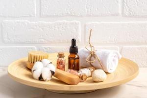 Close-up of bathroom beauty set in wooden basket on white background. Persona accessories on a table.