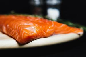 Fresh raw salmon fillet with seasonings and herbs photo