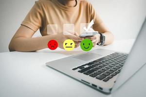 Customer satisfaction very good service with smart phone, impression of take care and attention, choose a smiley face icon, answer the survey, give the highest score, very happy feedback from guest. photo