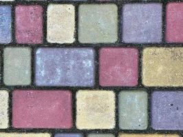 Texture of paving slabs of different colors. Background image is made of square-shaped stones. photo