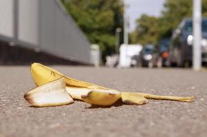 discarded banana skin on pavement photo