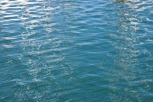 blue water surface with gentle ripples and reflections photo