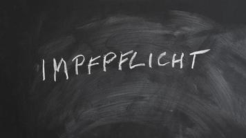 Impfpflicht translates as compulsory vaccination in German photo