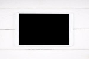 tablet computer with empty display on white wood photo