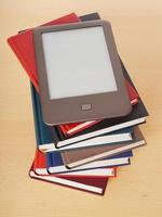 e-book reader on pile of books photo