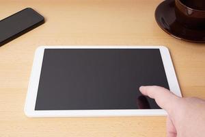 finger touching blank touchscreen on tablet computer photo