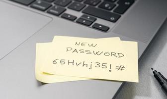Change of password to a stronger one- Message on sticky note on laptop. Computer security management concept photo