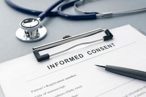 Informed Consent form and stethoscope on desk photo