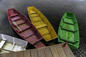 Four different colored wooden boats photo