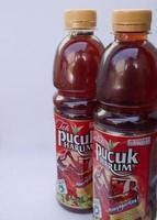 Sidoarjo, Jawa timur, Indonesia, 2022 -  2 bottles of fragrant shoots tea parallel to a white background photo