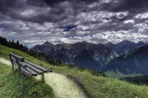 View of bench with mountains on background photo