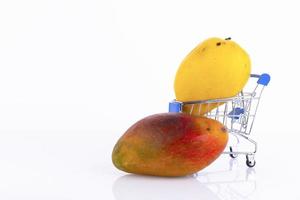 Various types of mango with yellow, red peel, a favorite Thai fruit in a shopping cart, on a white background. ECO, environmentally friendly product. Copy space. photo