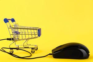 Internet online shopping concept with computer and cart. Copy space photo