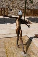 Portonovi, Montenegro, October 20, 2020 - Marina and park with a sculpture of a boy walks on water in a Mediterranean style, located among the wild beauty of Boka Kotorska Bay on the Adriatic Sea. photo