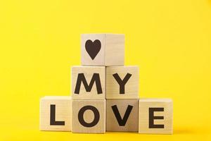 My love, text, letters are written on wooden cubes in the form of a pyramid, close-up. photo