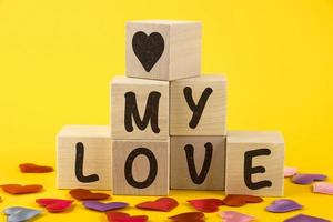 My love, text, letters are written on wooden cubes in the form of a pyramid, close-up. photo