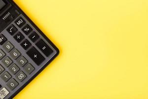 Modern calculator, Business and Finance accounting concept on yellow background with space for text. photo