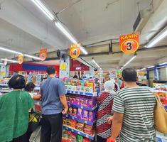 Jakarta, Indonesia in July 2022. People are waiting in line at the cashier of a supermarket to pay for the necessities they bought. photo