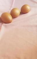 Eggs on a pink cloth. photo