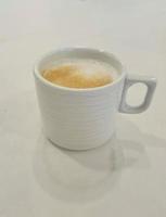 A glass of warm cappuccino photo