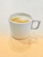 A glass of warm cappuccino photo