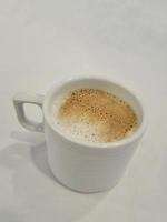 A glass of warm cappuccino photo