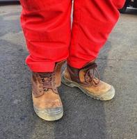 Healthy safety and environmental officers who wear red pants uniforms and brown safety shoes. photo