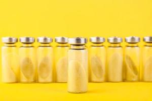 Bubbles, ampoules with dry probiotic, bifidobacteria, with probiotic powder inside on a yellow background. Copy space. photo