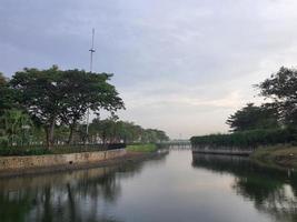 A view on a lake, with surrounding trees reflected in the lake water. photo