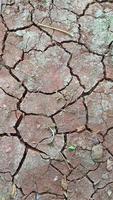 Red soil that begins to crack due to drought, lacks water content. photo