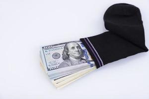 Money sock. a bundle of American hundred dollar bills hidden in a sock. Savings and storage concept. Selective focus photo