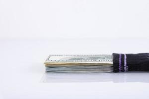 Money sock. a bundle of American hundred dollar bills hidden in a sock. Savings and storage concept. Selective focus photo