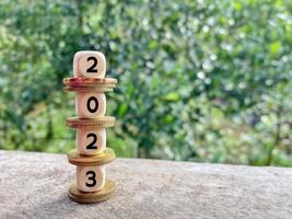 Business concept - 2023 on wooden cubes background. Stock photo. photo