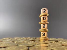 Finance and Economy of New Year Concept. 2023 text on wooden cubes background. photo