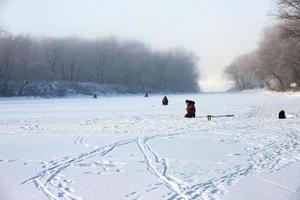 Ice fishing with fishermen. natural background, cold temperature. photo