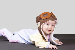 Baby aviator, wearing a pilot hat, close up portrait. photo