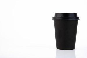 Black paper coffee cup with plastic lid on a white background. Copy space. photo