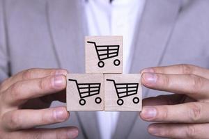 Increasing sales makes business successful, pyramid of cubes with a shopping cart icon and symbol. photo