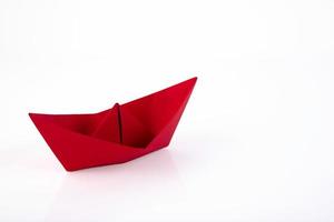 Red paper ship made of paper isolated on white background. Copy space. photo