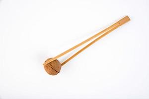 Ripe walnut in shell with wooden chopsticks, on a white background. photo